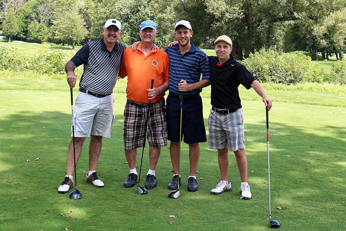 four men about to play golf