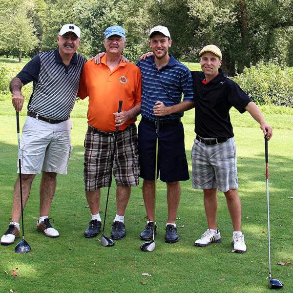four men about to play golf