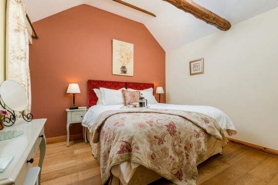 superking bed in a bedroom with vaulted ceiling 