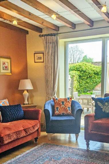 sitting room with large window looking onto a garden