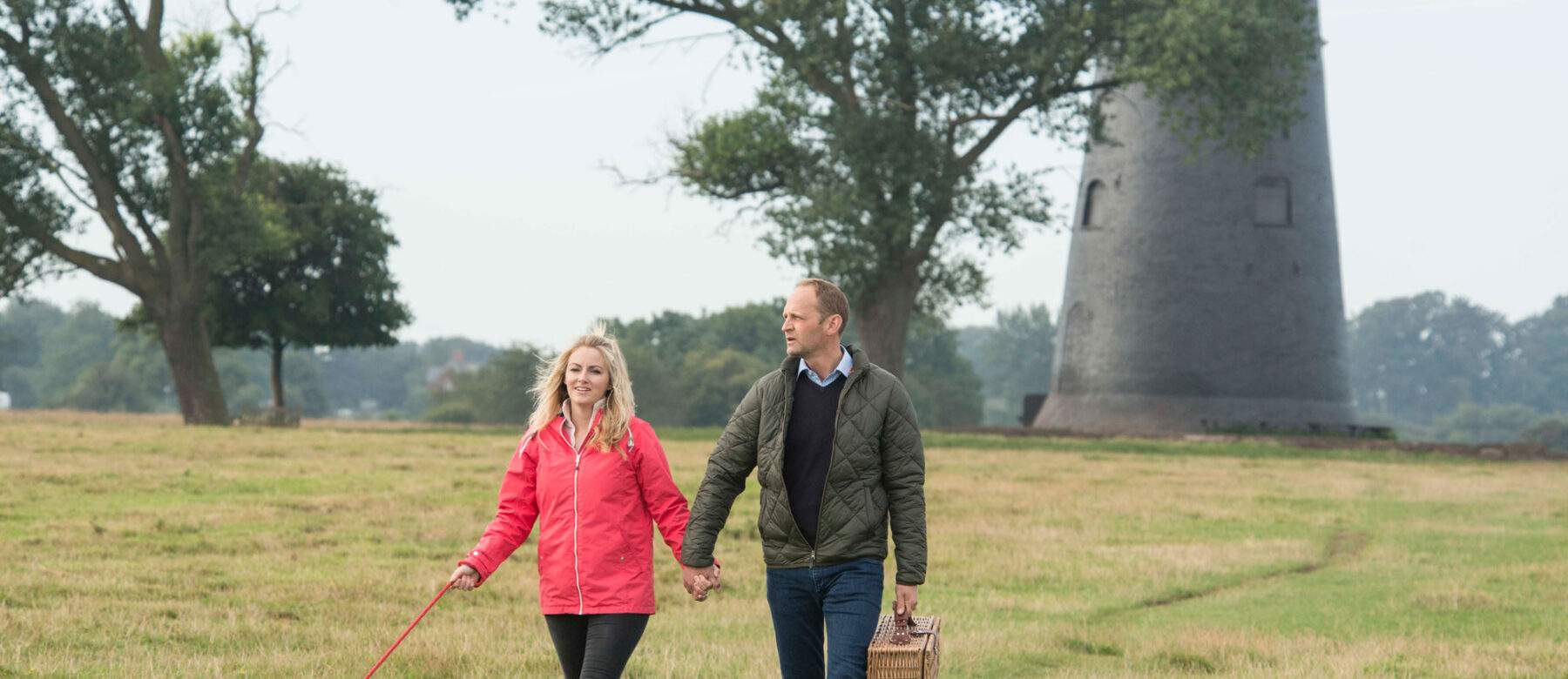 a couple walking by black mill on beverley westwood