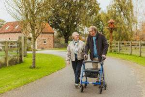 Couple walking with mobility aid