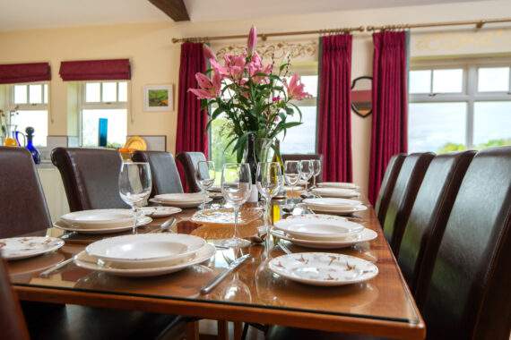 Table set for dinner with a centrepiece of lilies 