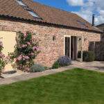 single storey brick cottage with french windows opening onto the private enclosed garden 