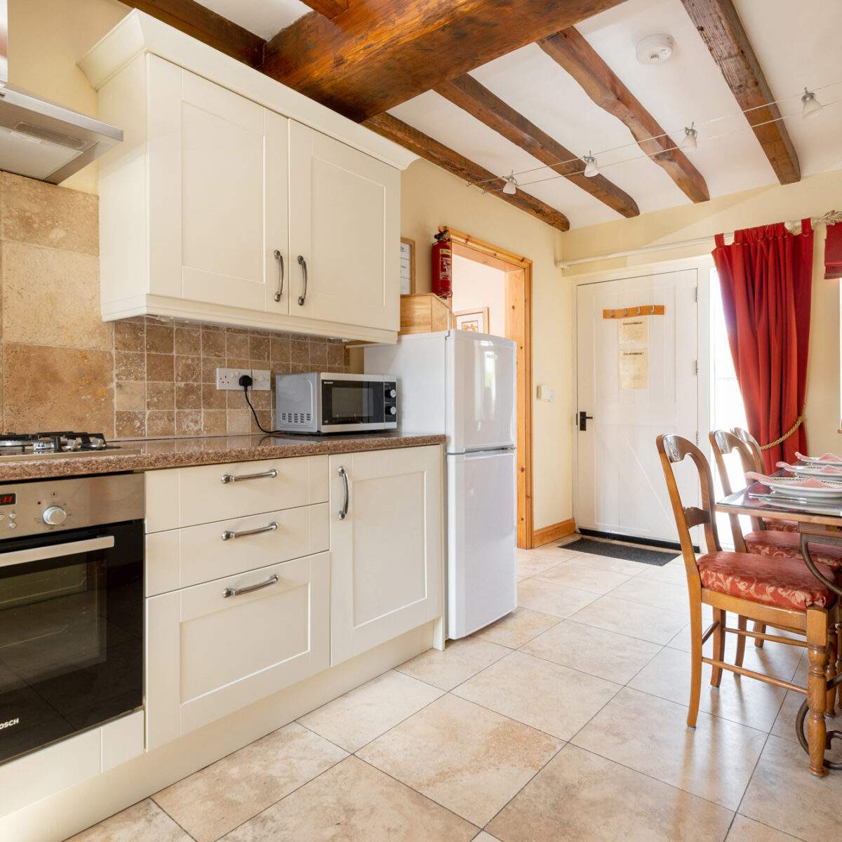 Foldyard kitchen 1 cream kitchen with dining table set for a meal