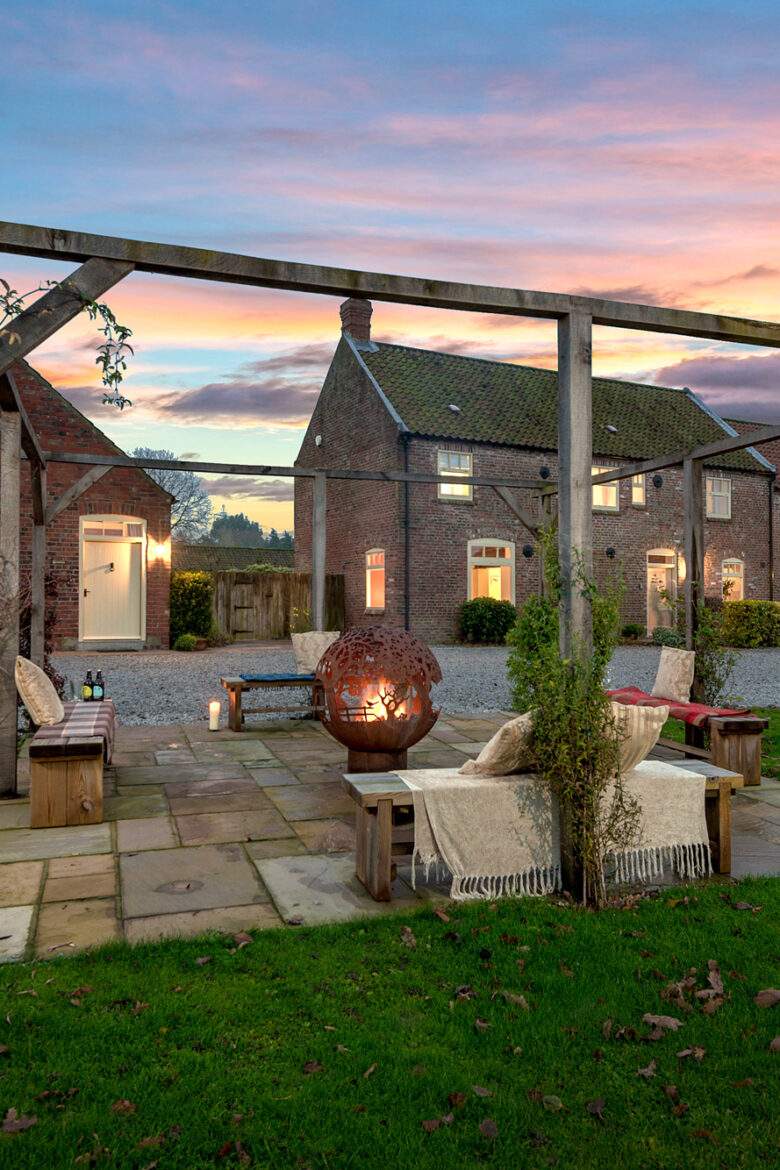 fireball lit on a night with cottages in the background