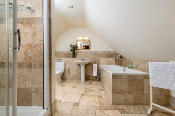 bathroom with bath and shower