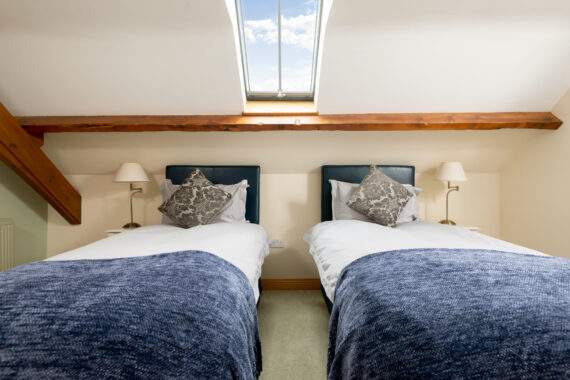 Bedroom with 2 single beds in the Forge at Broadgate Farm cottages. This room can also be set up as a superking. 