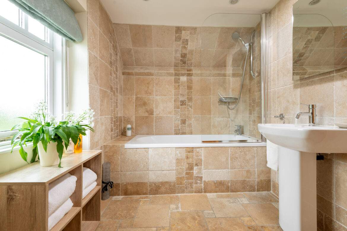 Family bathroom with shower over the bath in the forge two bedroom cottage