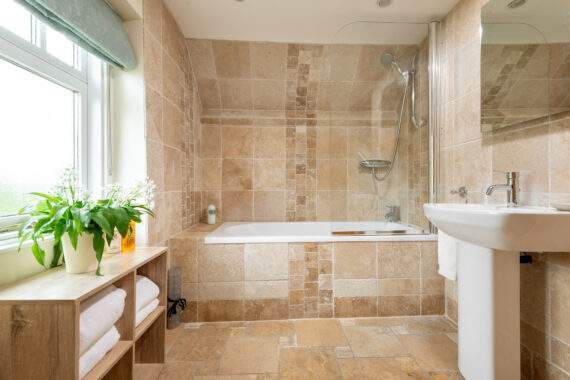 Family bathroom with shower over the bath in the forge two bedroom cottage 