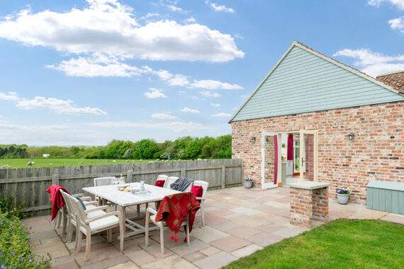 garden furniture on a patio outside a cottage 