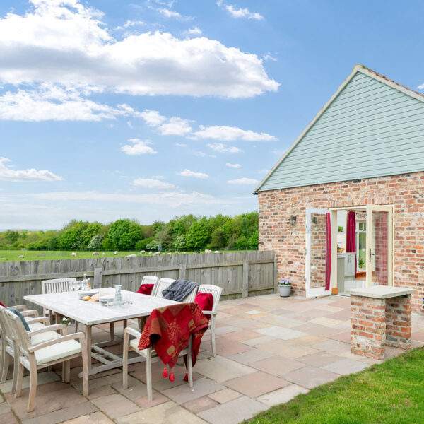 garden furniture on a patio outside a cottage