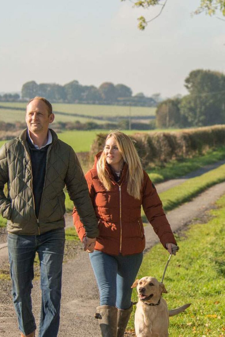 A couple walking with their dog in the Yorkshire Wolds - VHEY