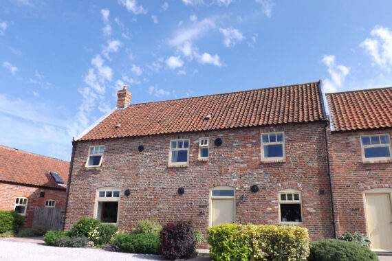 View of Granary cottage with lovely blue skies 