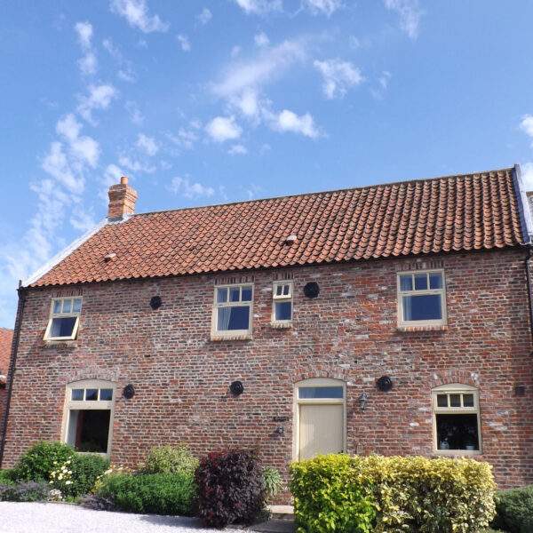 View of Granary cottage with lovely blue skies