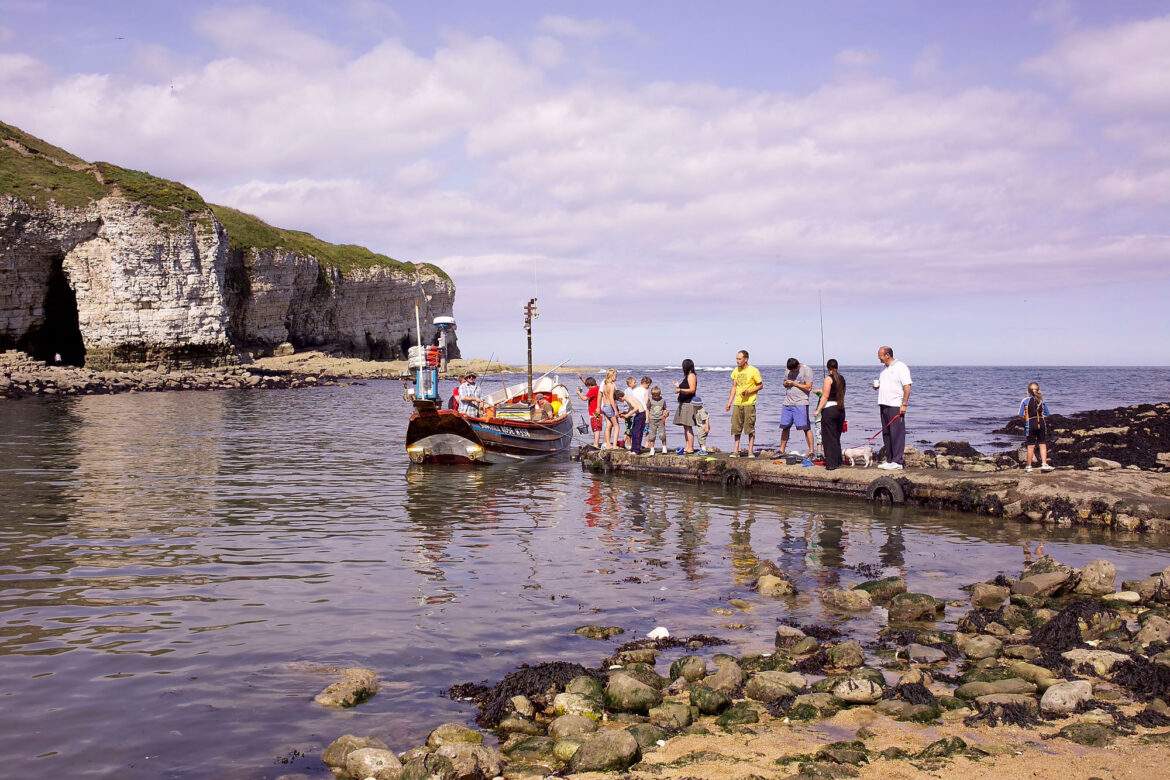people queueing to board a boat