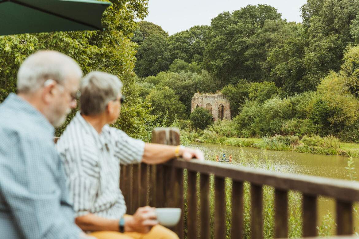 couple having coffee by a lake